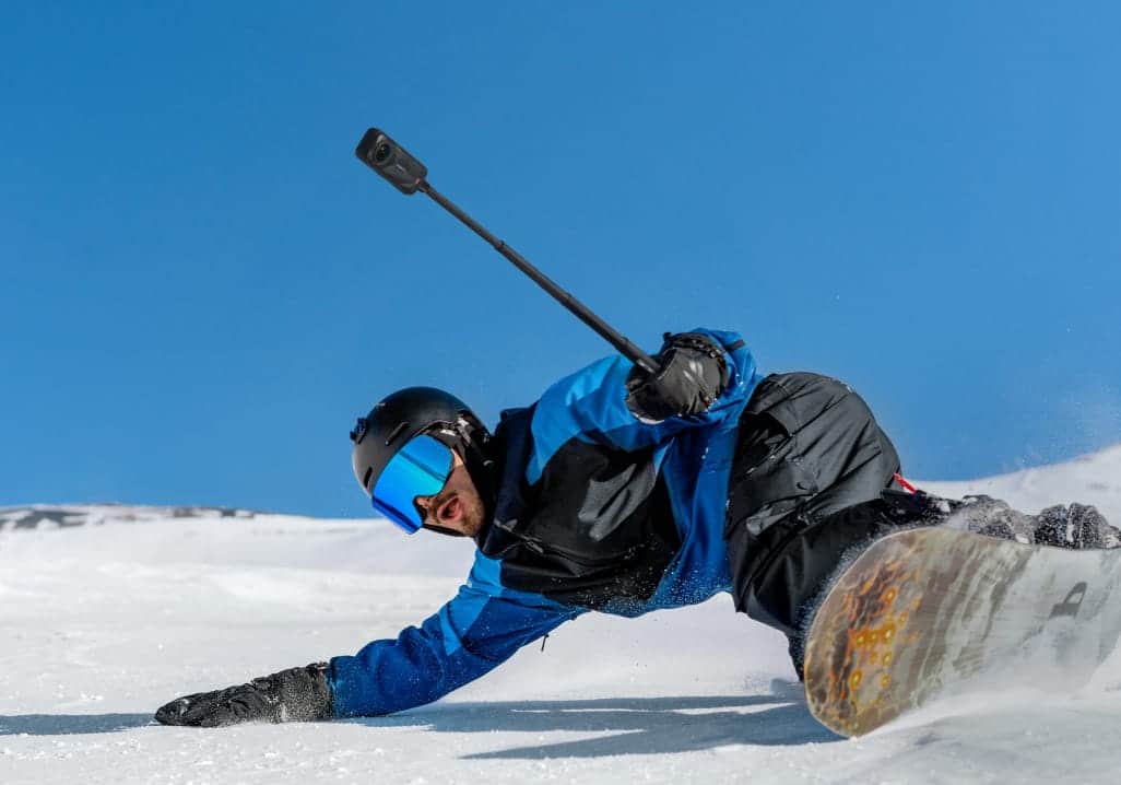 Insta360 X5 in action with a male snowboarder.